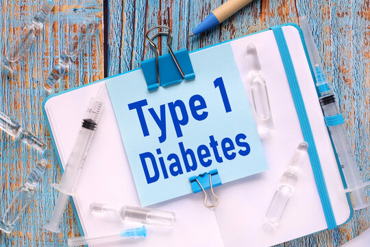 diabetes type 1. the sticker is attached to the notebook with a clerical clip. notebook on a wooden table in blue