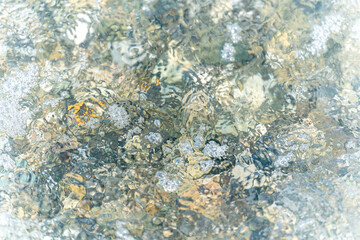 Fototapeta na wymiar Background, an abstraction of wet pebbles washed by a sea wave
