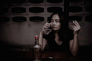 Asian woman drink vodka alone at home on night time,Thailand people,Stress woman drunk concept