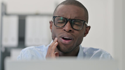 Close Up of African Man having Toothache at Work