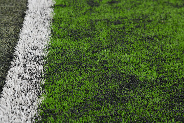 Textures and details of green artificial grass football field