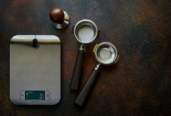 Exact scales and portofilters for coffee on a dark background with copy space, espresso recipe concept