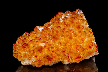 Macro mineral stone Citrine in rock in crystals on a black background