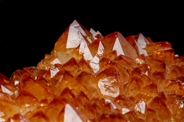 Macro mineral stone Citrine in rock in crystals on a black background