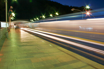 City lights at night, the subway is approaching the peron in the big city