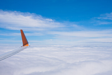 The wing tips of the airplane against the clear blue sky background while travelling in the summer.