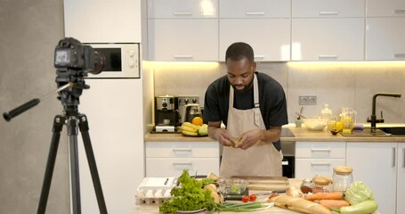 Handsome man filming cooking show or blog