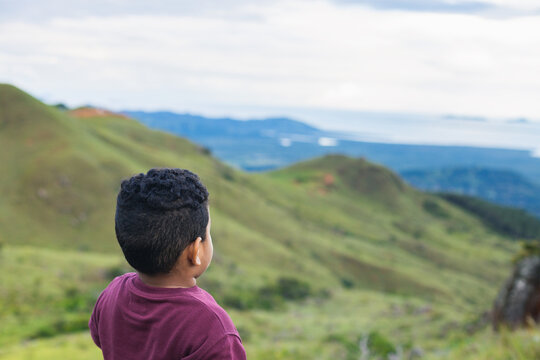 Hispanic Boy From Back Looking At The Landscape