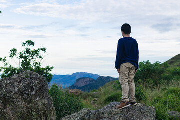 hispanic boy from back looking at the landscape