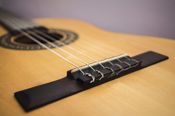 Fototapeta premium Classic guitar with nylon strings, with yellow-tinted top wood, with mahogany easel
