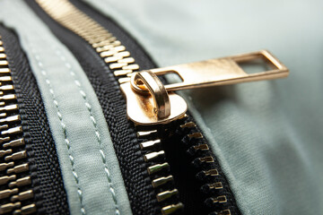 Metal zipper on nylon texture, closeup or macro view. Fastener on jacket 