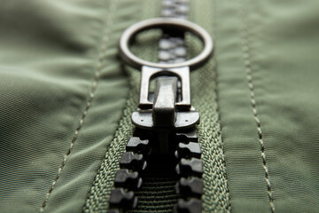 Metal zipper on nylon texture, closeup or macro view. Fastener on jacket  © Random435