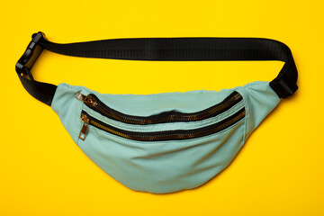 Belt bag on yellow background. Top view of casual waist bag