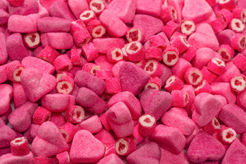 Assorted tasty gummy candies. Pink jelly sweets background.