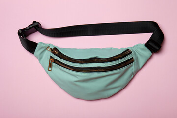 Belt bag on pink background. Top view of casual waist bag
