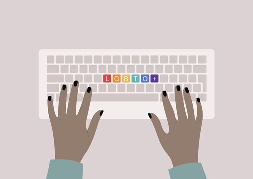 Hands typing on a keyboard, top view, rainbow buttons with an LGBTQ+ sign, queer community support
