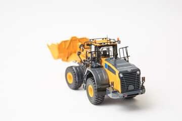 Highly detailed yellow single-bucket forklift, scale model of specialized equipment on white background, bulk loader.