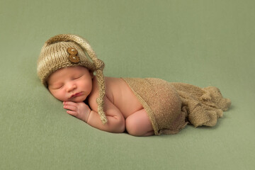 Sleeping baby with brown hat and wrap