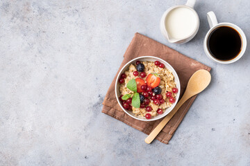 Breakfast table with granola, fresh berries and coffee with milk. Top view.