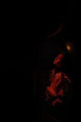 girl in a dark mysterious room with red lights on it   