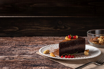 Raw vegan chocolate cashew cake on dark vintage background