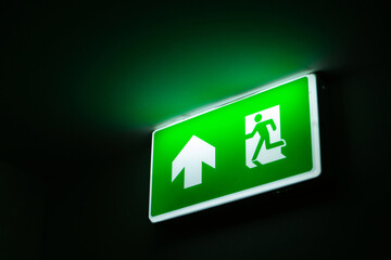 Glowing sign indicating the exit from the room