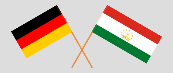 Crossed flags of Germany and Tajikistan. Official colors. Correct proportion