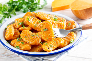 Delicious pumpkin gnocchi with olive oil, vegan food.