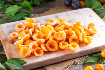 Frozen berries on the table. Frozen plums, cherry plums in bags and containers.