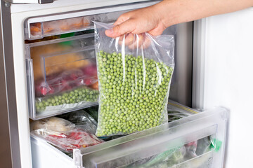 Frozen green peas in the freezer. Frozen vegetables