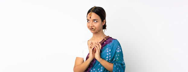 Young indian woman isolated on white background scheming something