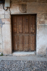 wooden door to access the house, old and made of elaborated wood.