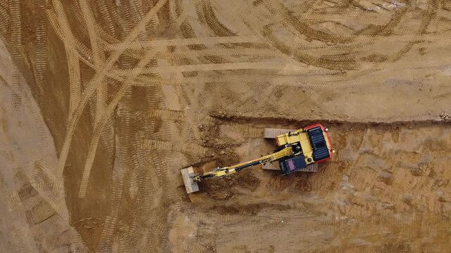 Aerial video of excavator digger and bulldozer working side by side on construction