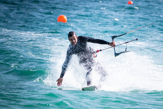 Young man kitesurfing