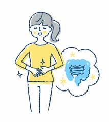 お腹に手を当てている笑顔の女性　健康的な腸のイメージ