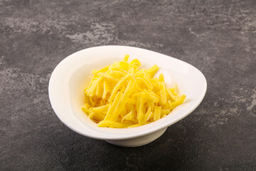 Shredded yellow cheese in the bowl