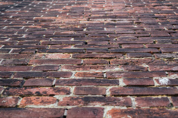 Brick old wall of dark red color. Horizontal vintage background. Exterior.