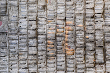 The wall is made of large white old bricks from Soviet times.