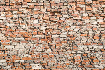 Old brick wall of light red color.  Horizontal vintage background. Exterior.