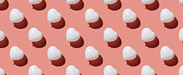 Pattern of white balloons on pastel pink background