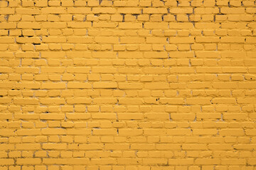 Yellow brick wall close-up horizontally. Yellow background. Construction and architecture.