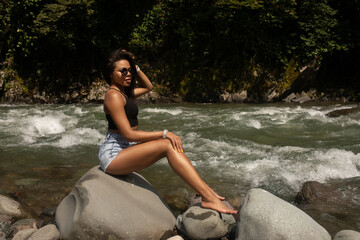 Fototapeta premium Young black woman tourist relaxes in river.
