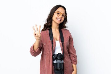 Obraz premium Young photographer woman over isolated white background happy and counting three with fingers