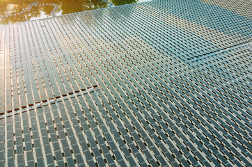Aerial top view of solar panels cells on floating in pond the power plant with water, renewable...