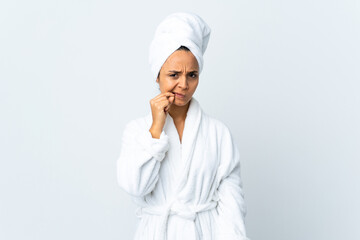Young woman in bathrobe over isolated white background showing a sign of silence gesture