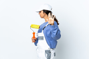 Painter woman over isolated white background making stop gesture and covering face