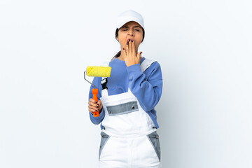 Painter woman over isolated white background yawning and covering wide open mouth with hand