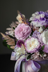 Beautiful bouquet of purple roses on a dark background, soft and romantic. Still life with a flowers. Still life with a bouquet.