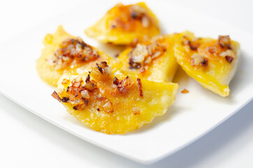 Fried dumplings sprinkled with fried onion, traditional Polish, Russian and Ukrainian cuisine