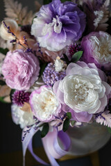 Beautiful bouquet of purple roses on a dark background, soft and romantic. Still life with a flowers. Still life with a bouquet.